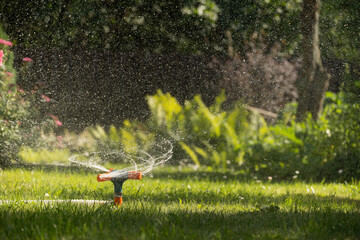 Green lawn automatic irrigation system in park. Close up. Automatic smart irrigation system.