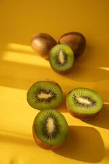 Kiwi on a wooden board. on a yellow background. fruit