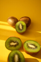 Kiwi on a wooden board. on a yellow background. fruit