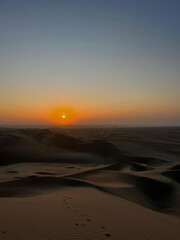 Sunset view over desert and sand dunes 