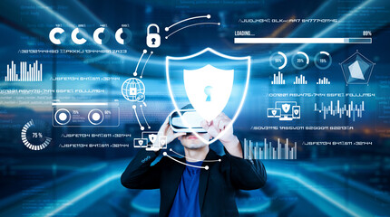 Project manager pointing security system hologram and standing at futuristic office with blue...