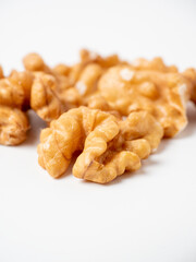 close-up of shelled walnuts on a white background. Food that's good for your mind, blurred background