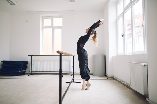 Ballet dancer practicing at barre