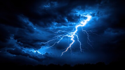 Powerful lightning strikes a dark stormy sky.  Dense clouds fill the night