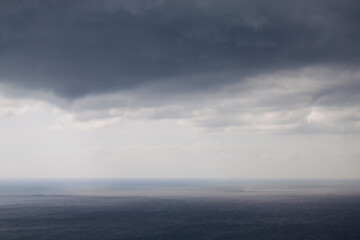 A stunning, mesmerizing view of the seascape, the dark black sea and cumulus thunderstorm large...