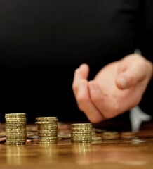 saving coins with money to pay bills having the intention of calculating raising more money to be wealthy with people stock image stock photo