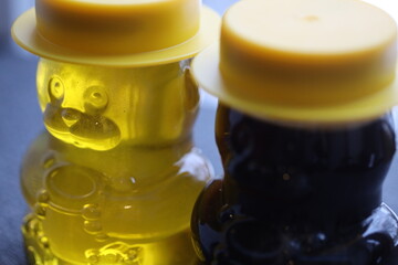 A jar of a bear filled with honey.