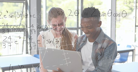 In school, students collaborating on laptop solving complex math equations together
