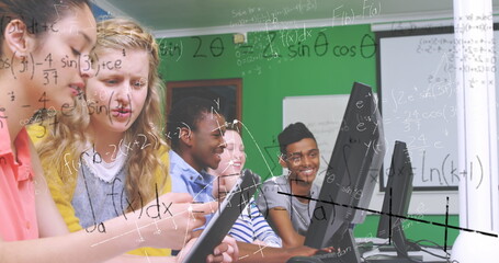 In school, students using computers collaborating on math project, staying engaged