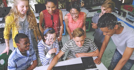 In school, diverse students collaborating on laptop, solving math problems together