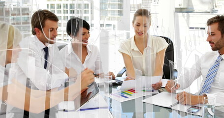 Collaborating in modern office, business team discussing documents and ideas around table