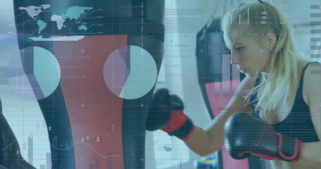 Woman training with punching bag, digital interface overlay showing data and graphs