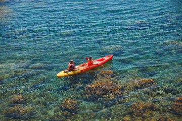 Two people floating in a canoe. View from above