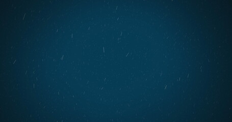 Digital image of white particles falling against blue background