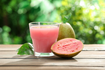 Refreshing guava juice and fresh fruits on wooden table, closeup