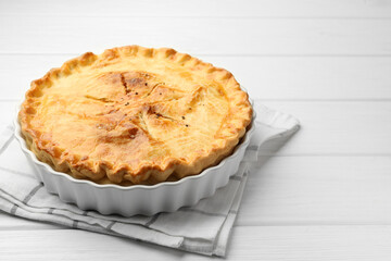 Delicious fresh homemade pie on white wooden table, closeup. Space for text