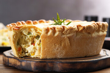 Delicious fresh homemade pie with rosemary on table, closeup