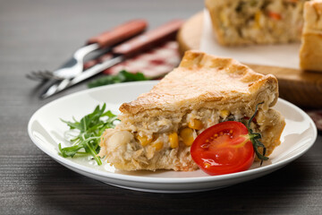 Piece of delicious fresh homemade pie served on wooden table, closeup