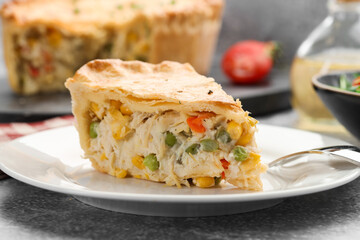 Piece of delicious fresh homemade pie served on gray textured table, closeup