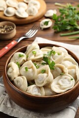 Delicious dumplings served on wooden table, closeup