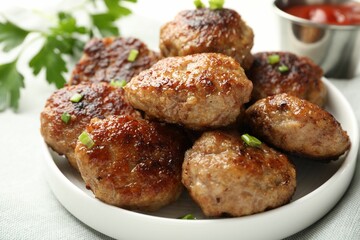 Delicious patties with green onions on table, closeup
