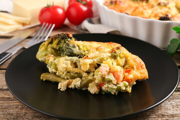 Tasty vegetable casserole on wooden table, closeup