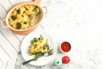 Tasty vegetable casserole served on white marble table, flat lay. Space for text