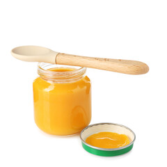 Baby food. Tasty puree in glass jar and spoon isolated on white