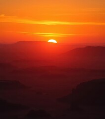 Obraz premium Golden hour sunset paints a vast desert landscape in fiery hues, shadows lengthening, wild, silence