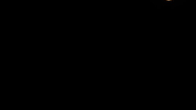 A full moon setting in the night sky