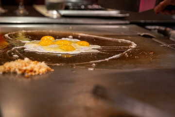 Frying eggs on a flat grill