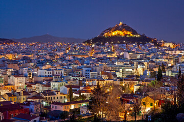 Stunning panoramic view of Athens at night with illuminated Lycabettus Hill. A breathtaking cityscape capturing the charm of Greece’s capital.