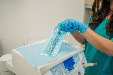 Dentist preparing sterile dental tools for surgery