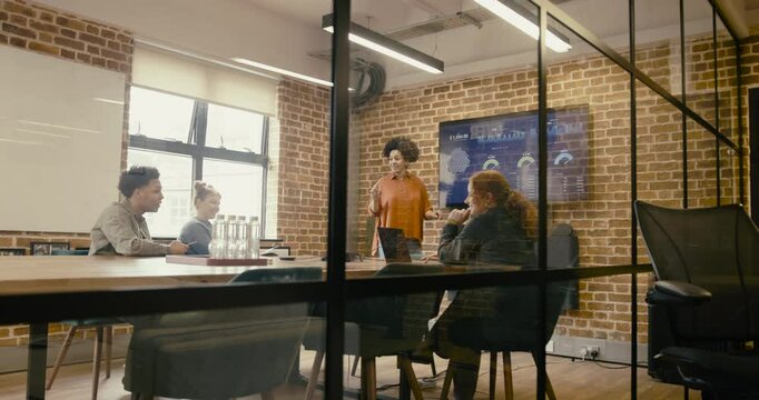 Businesswoman Presenting during Meeting in Boardroom Office