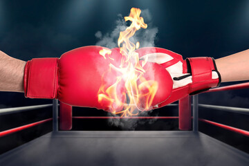 Boxers fighting in boxing ring, closeup. Smoke and flames between their hands