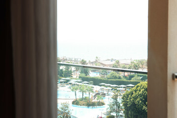 Fototapeta premium Beautiful view on luxury resort through glass window from hotel room