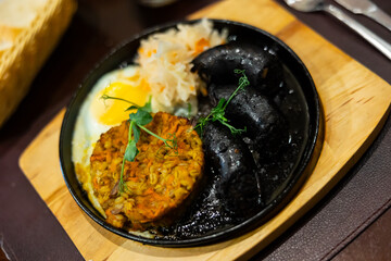Blood sausage with barley salad and egg served on platter