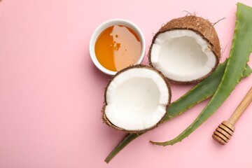 Hair treatment. Fresh coconut, honey and aloe leaves on pink background, flat lay. Space for text