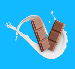 Yummy chocolate pieces and splashes of milk in air on light blue background
