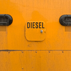 Locked Diesel Fuel Tank on the side of a bright yellow school bus. Closeup view.