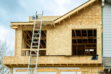 major home renovation top floor framing seen from outside with chipboard clad walls ready to be...