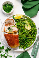 Chicken Kiev with green vegetables, peas and green beans