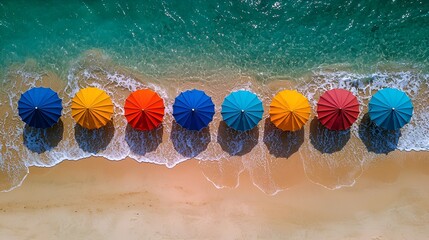 Colorful beach umbrellas on sandy shore, ocean waves