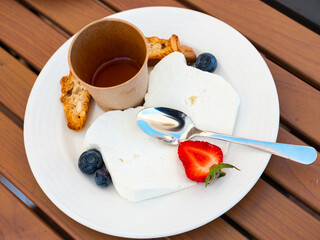 Delicious mato cheese with honey and berries served for dessert