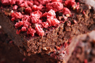 Closeup of homemade gluten-free brownies made with red kidney beans, oat flakes, chocolate and freeze-dried raspberries