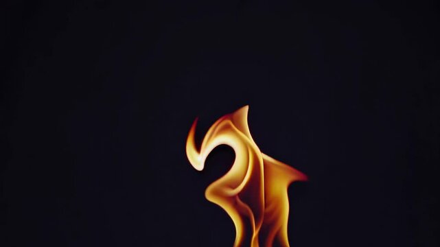 Abstract video of flames resembling a dancer and heart, captured from a low angle against a dark background, creating a dynamic and artistic effect. Live desktop wallpaper.
