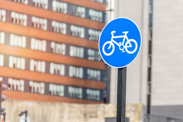 Close up of a round bicycle only road sign marking a bicycle lane in a city centre