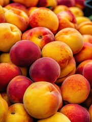 Fresh and Juicy Peaches and Nectarines Piled Together in a Colorful Display at a Local Farmers Market, Perfect for Summer Recipes and Healthy Eating