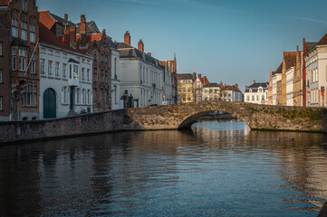 Fototapeta premium Bruges Canals Reflecting Historic Architecture at Sunset