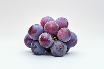 A bunch of ripe purple grapes on a white background